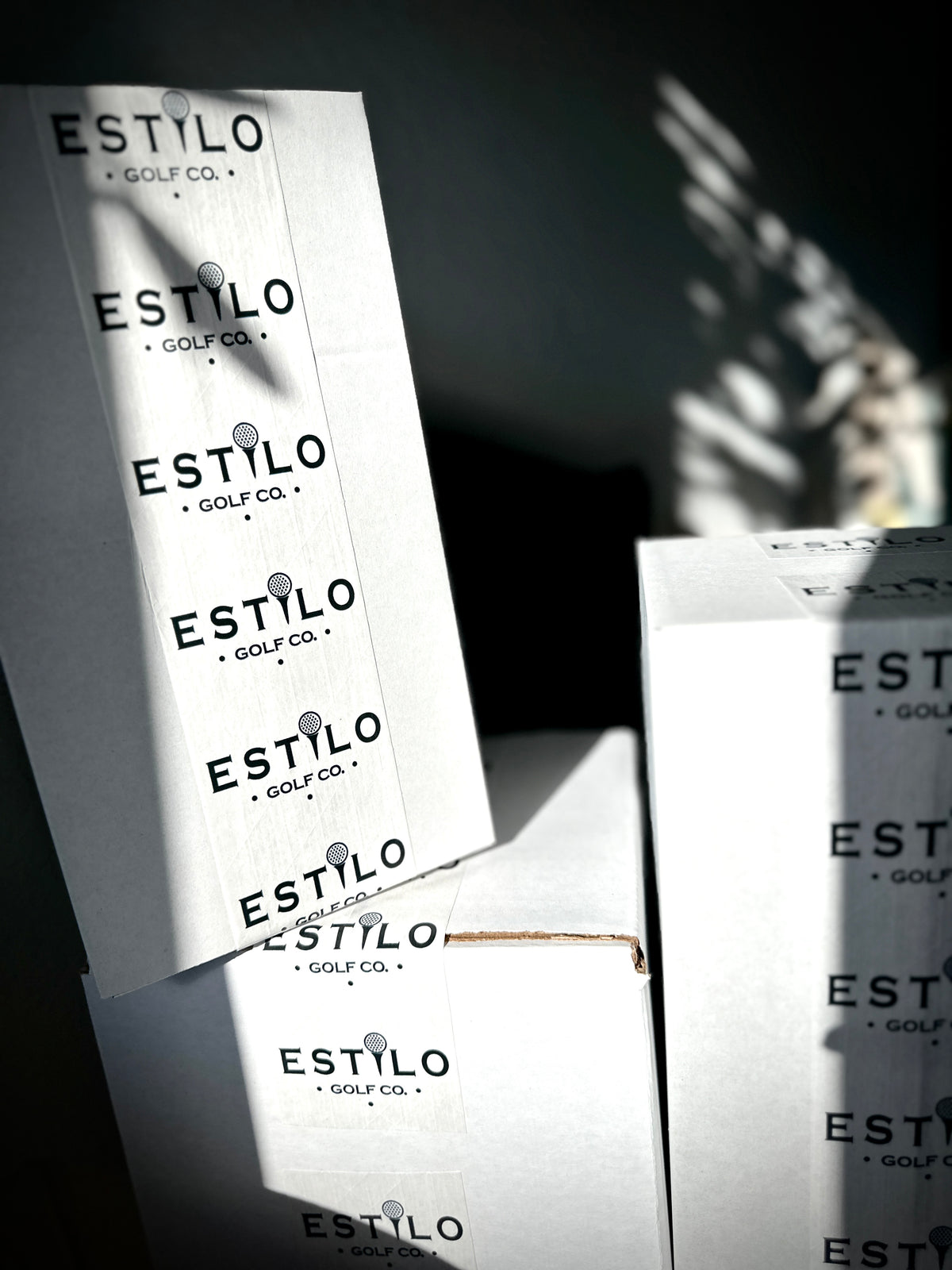Estilo Golf Co. packaging and logo labels in natural light