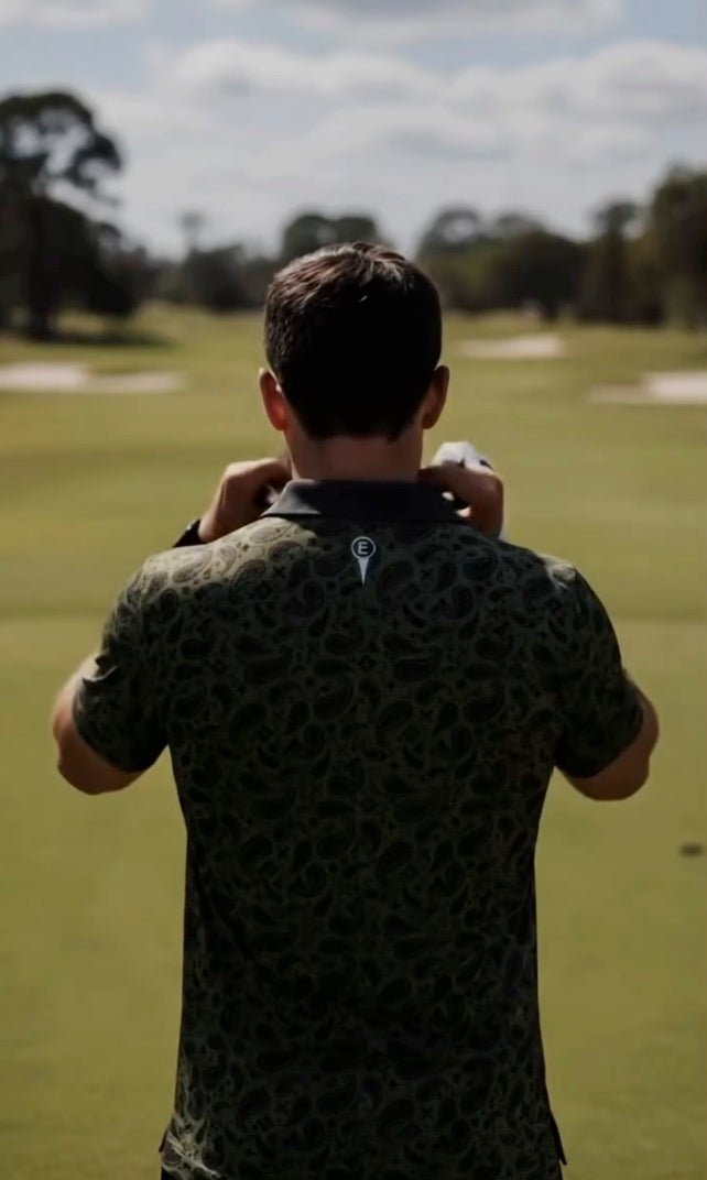 Golfer wearing an Estilo polo while looking across the course