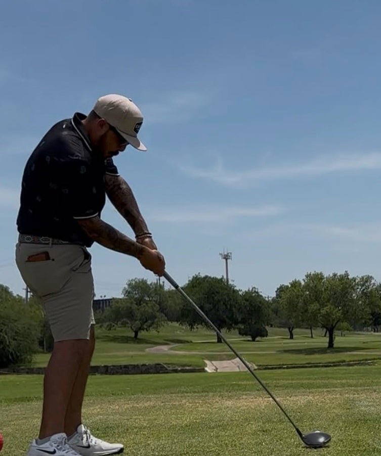 Estilo customer swinging a driver on a golf course